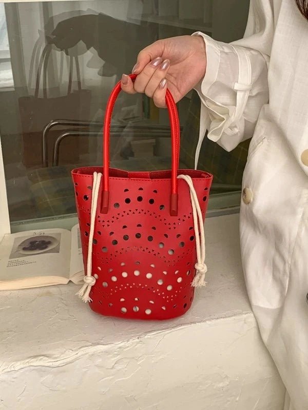Lara bucket-taske med udskæringer